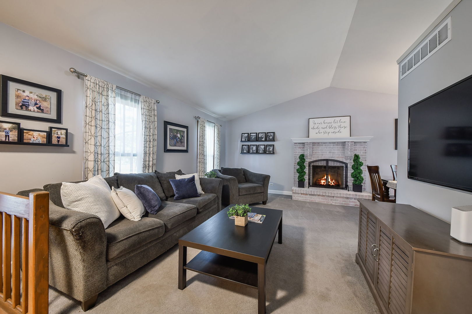 27W108 Walnut Drive Winfield, IL 60190 - Photo 2 of 20 a living room with furniture a flat screen tv and a fireplace