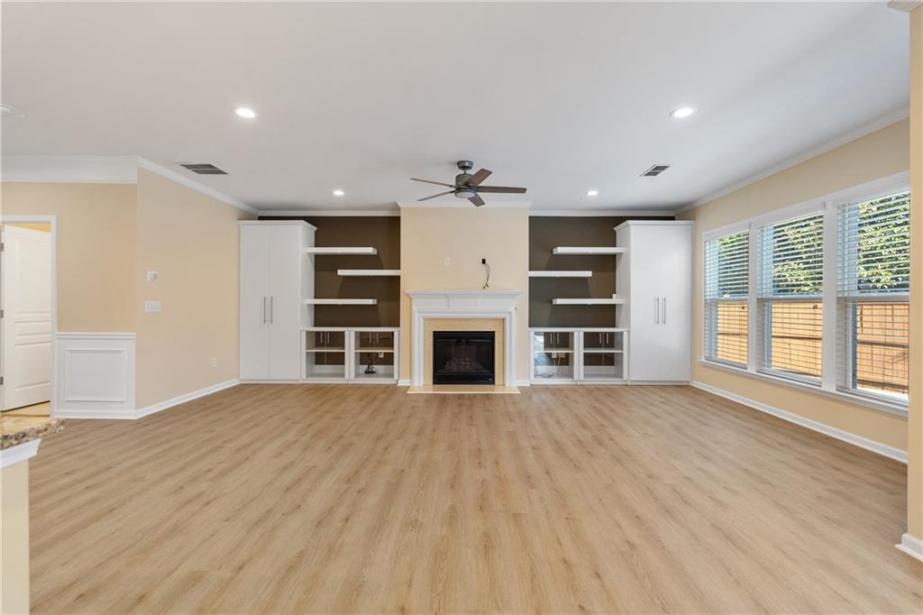 865 Great Glen Place Suwanee, GA 30024 - Photo 12 of 45 a view of a livingroom with a fireplace and windows