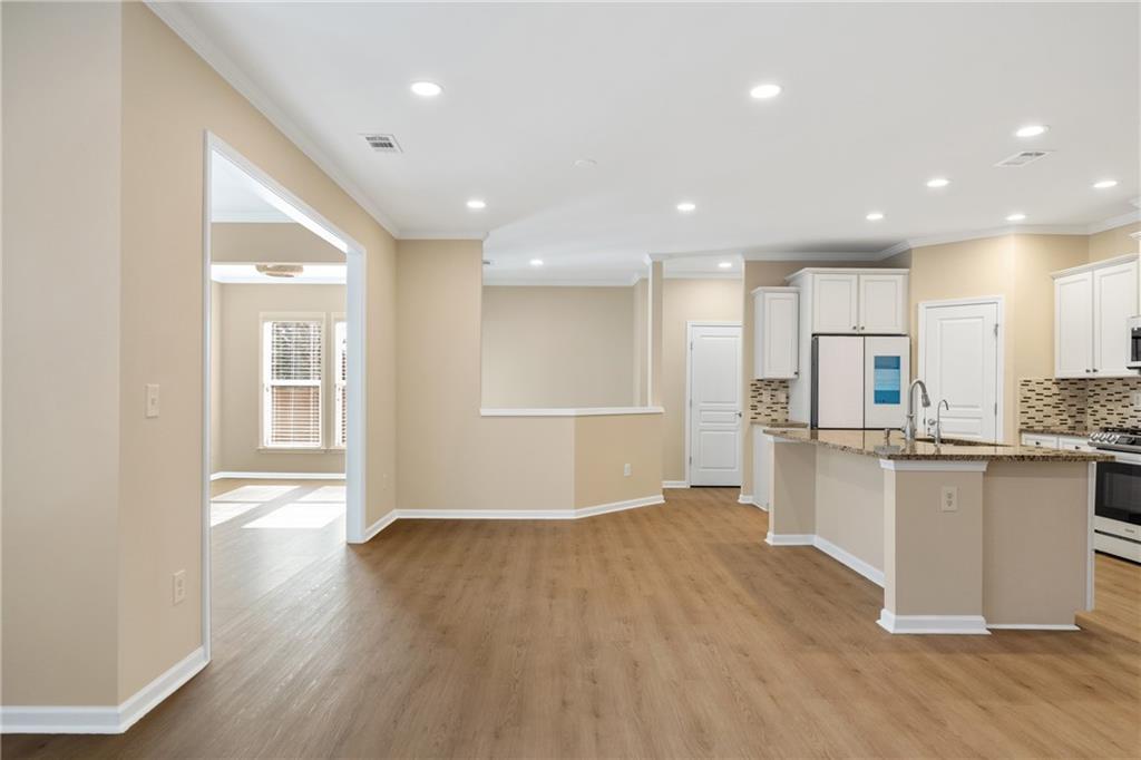 865 Great Glen Place Suwanee, GA 30024 - Photo 16 of 45 a view of kitchen with cabinets and wooden floor