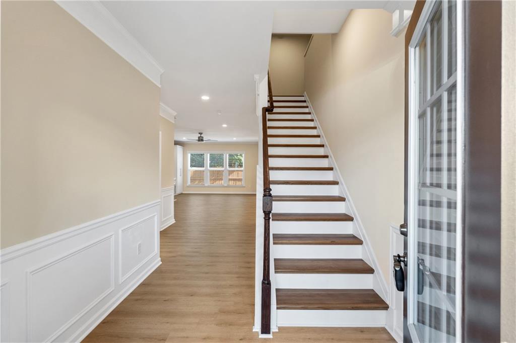 865 Great Glen Place Suwanee, GA 30024 - Photo 25 of 45 a view of a hallway with stairs and wooden floor