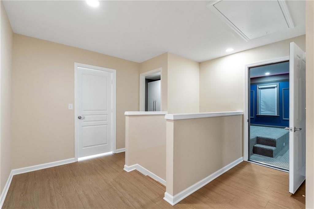 865 Great Glen Place Suwanee, GA 30024 - Photo 27 of 45 wooden floor in an empty room with a window