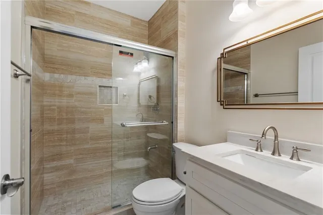 a view of a big room with wooden floor closet and windows