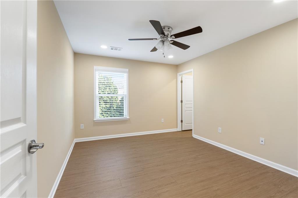 865 Great Glen Place Suwanee, GA 30024 - Photo 32 of 45 a view of a big room with wooden floor closet and windows
