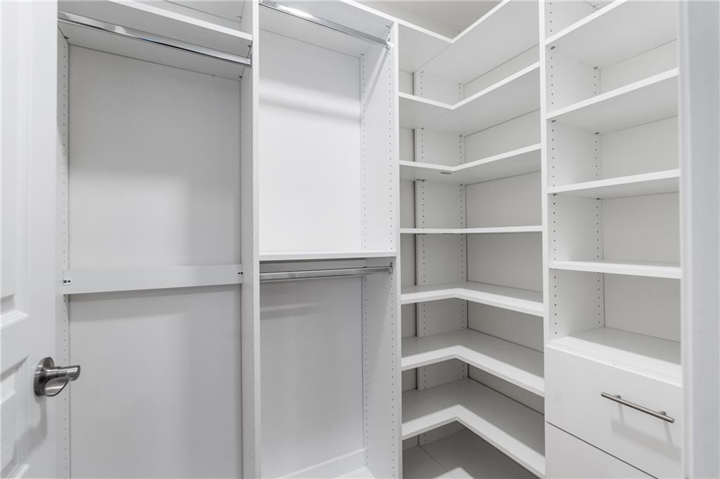 865 Great Glen Place Suwanee, GA 30024 - Photo 39 of 45 a view of walk in closet with empty racks