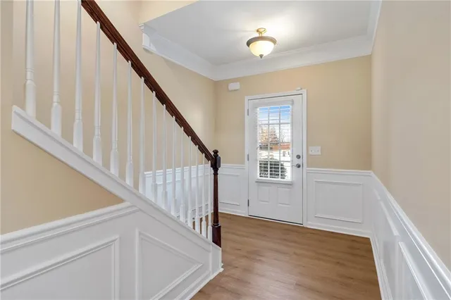 a view of entryway with wooden floor and stairs
