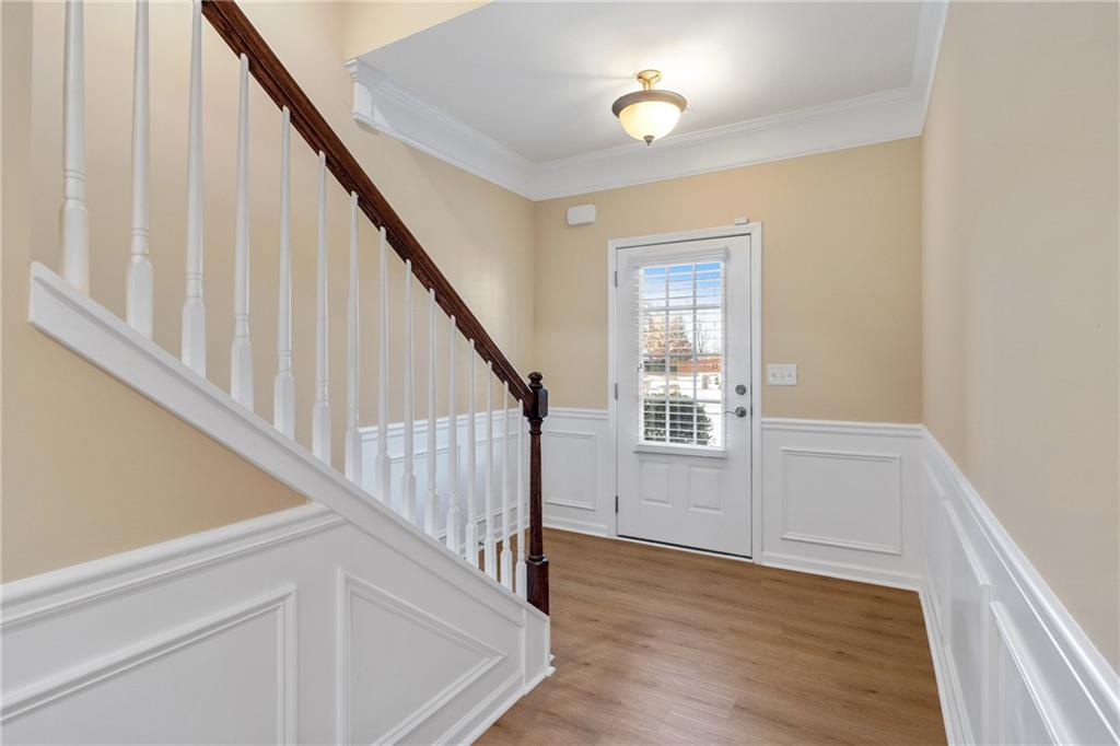 865 Great Glen Place Suwanee, GA 30024 - Photo 4 of 45 a view of entryway with wooden floor and stairs