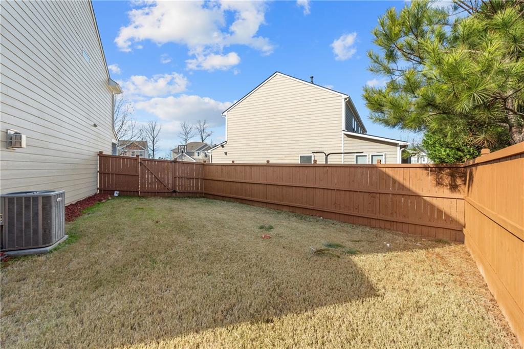 865 Great Glen Place Suwanee, GA 30024 - Photo 44 of 45 a view of backyard with barbeque and wooden fence