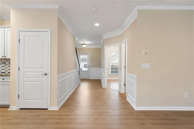 a view of a hallway with wooden floor
