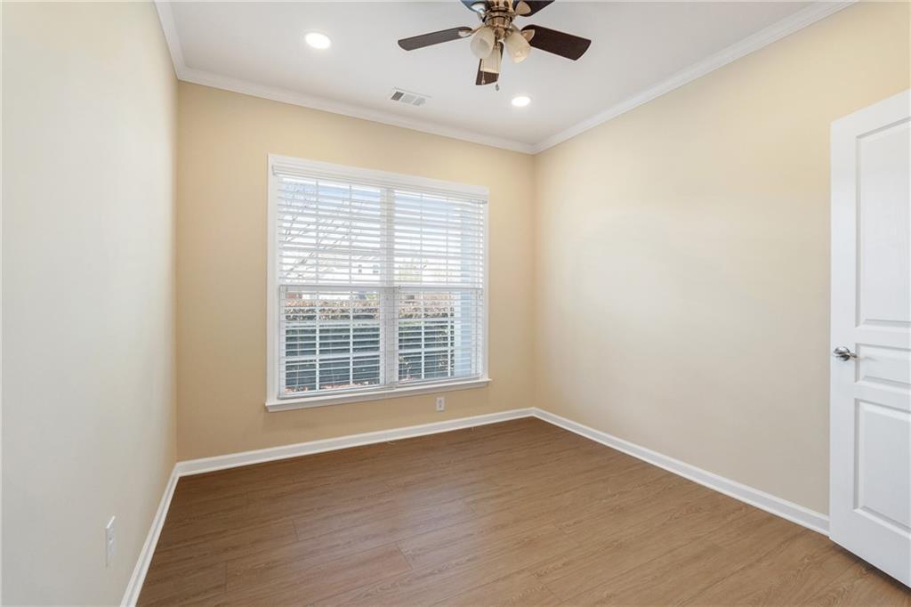 865 Great Glen Place Suwanee, GA 30024 - Photo 6 of 45 an empty room with a window and a fan