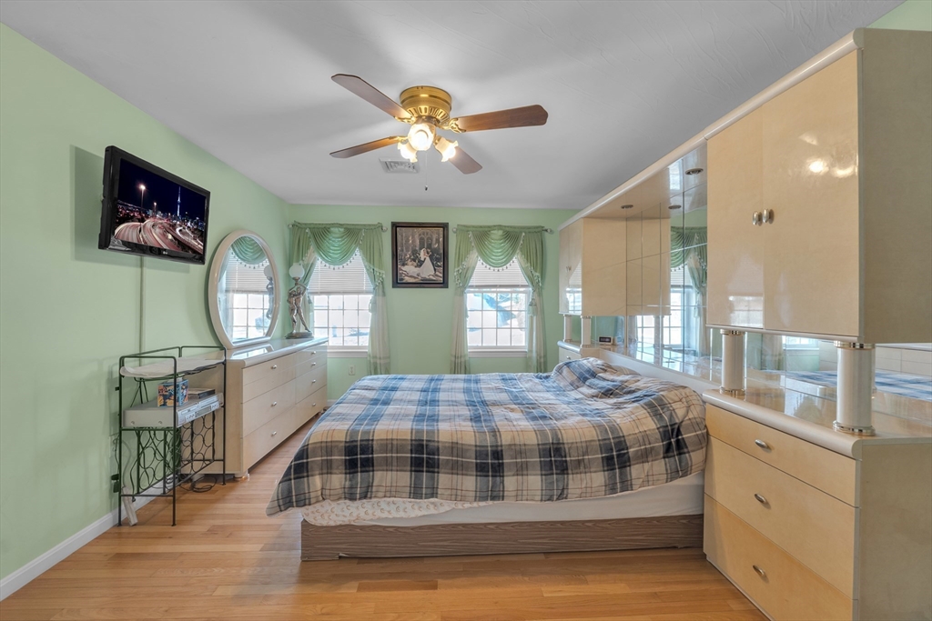 8 Modred Court Worcester, MA 01602 - Photo 15 of 28 a bedroom with a bed and a chandelier