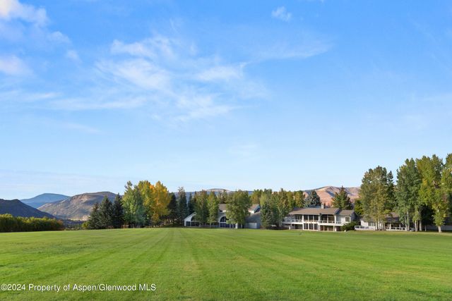 a view of a green field with clear sky