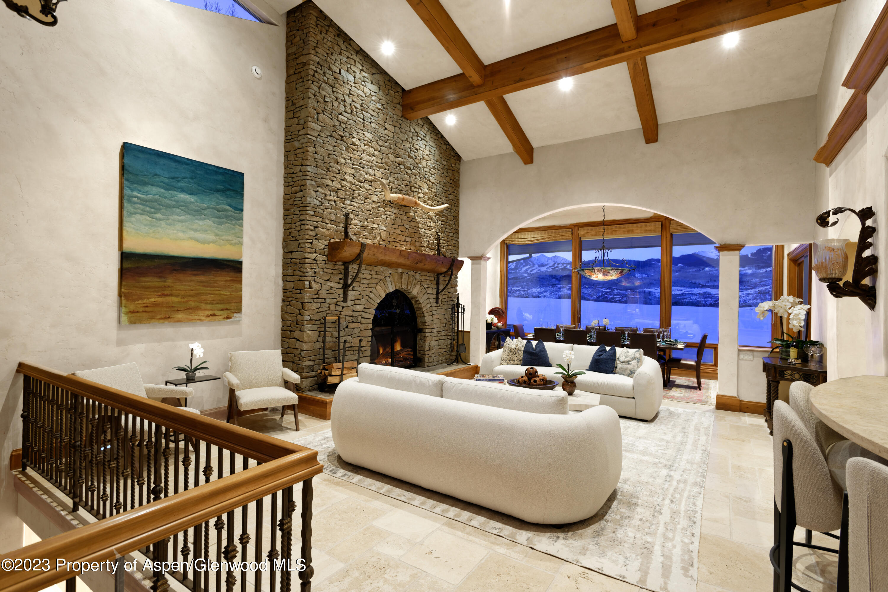 1650 McLain Flats Road Aspen, CO 81611 - Photo 26 of 72 a living room with furniture stairs and a fireplace