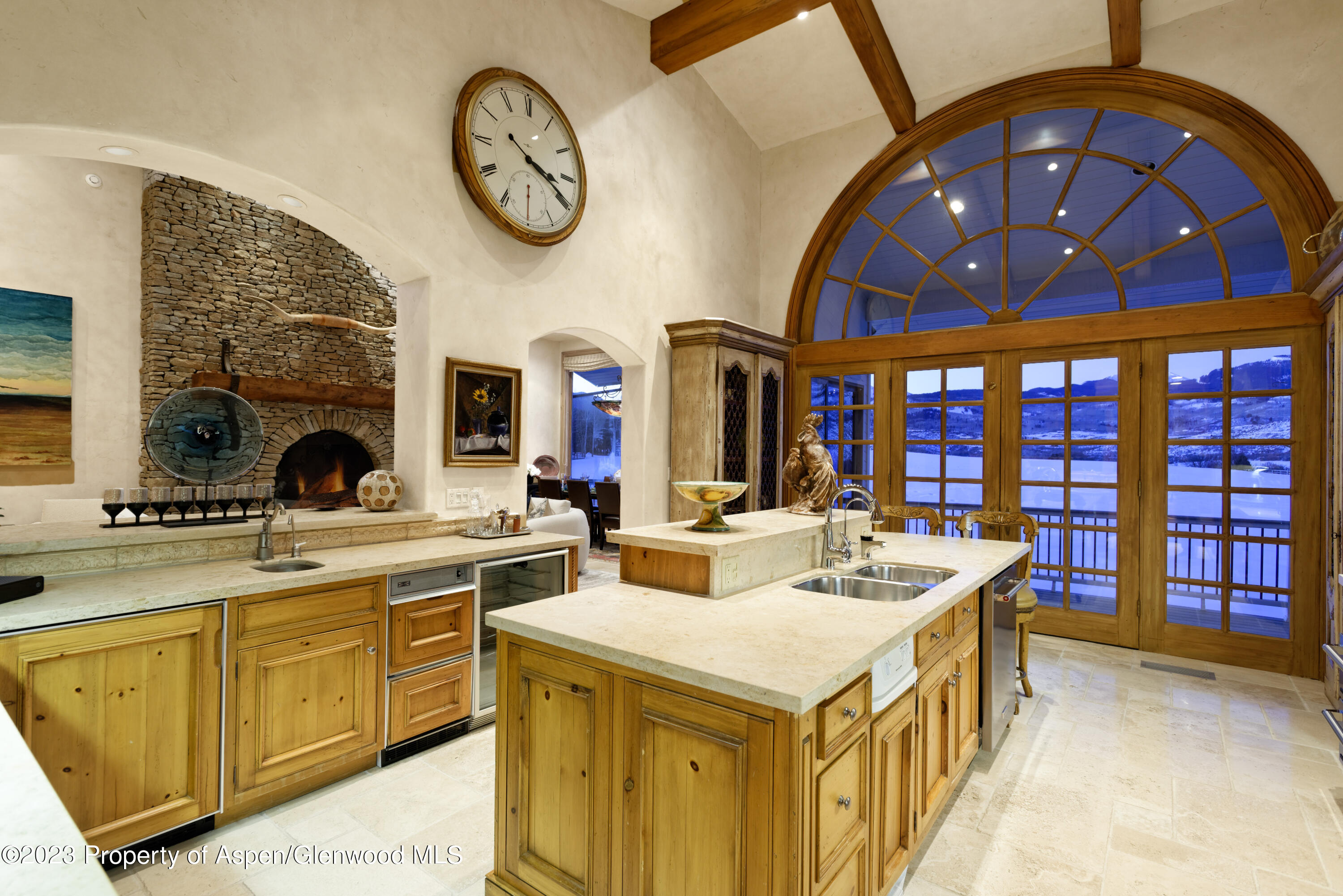 1650 McLain Flats Road Aspen, CO 81611 - Photo 29 of 72 a kitchen with a stove a clock and a clock on the wall