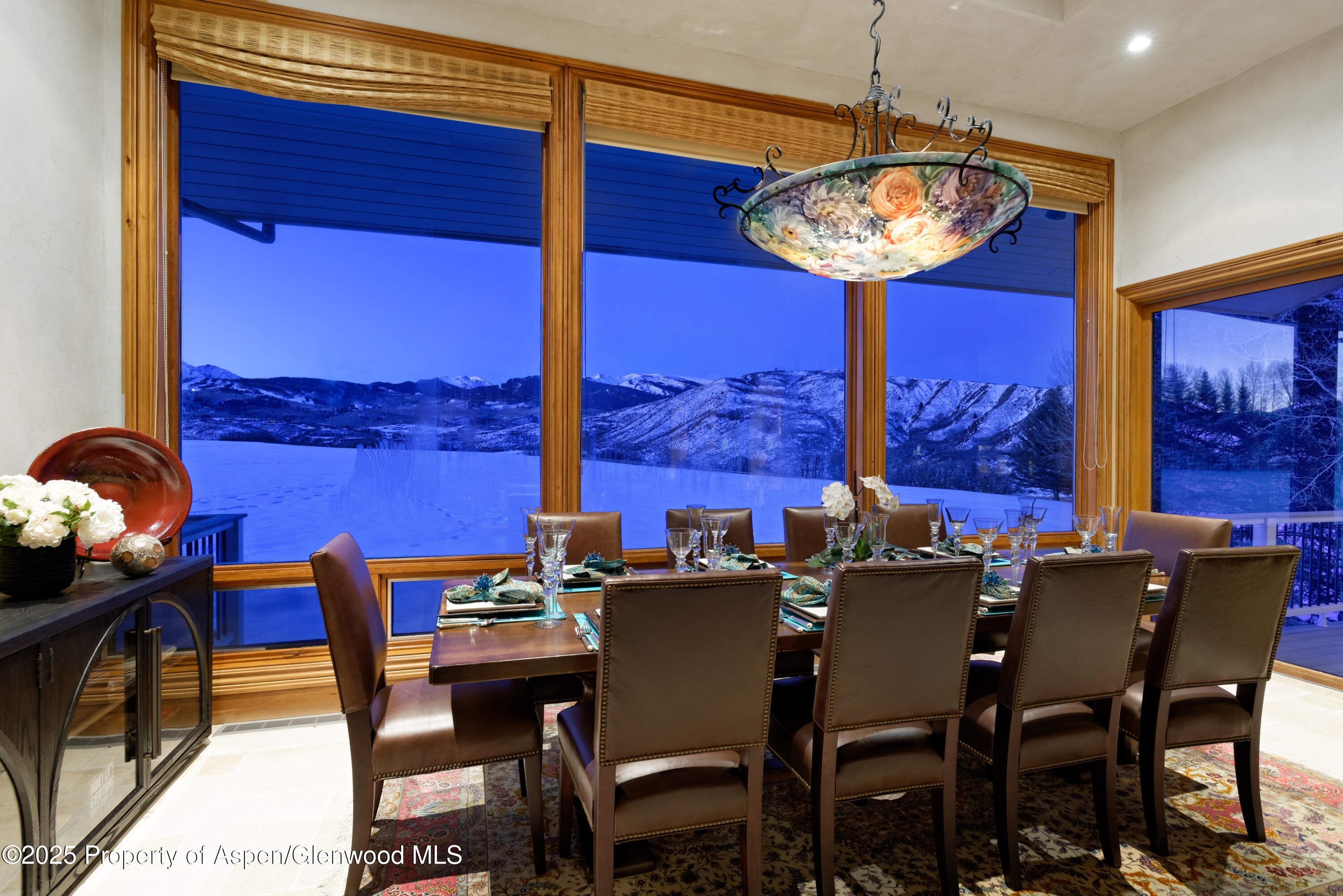 1650 McLain Flats Road Aspen, CO 81611 - Photo 32 of 72 a dining room with furniture a chandelier and window