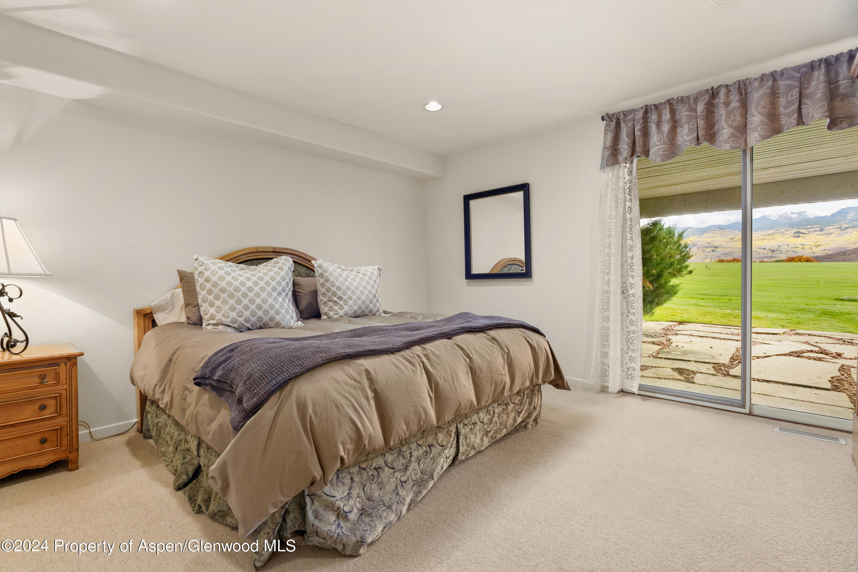 1650 McLain Flats Road Aspen, CO 81611 - Photo 40 of 72 a bedroom with a bed and large window