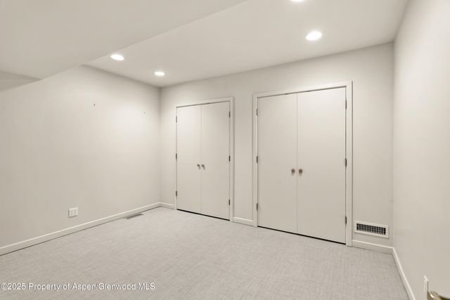 a view of a tennis ground with large trees