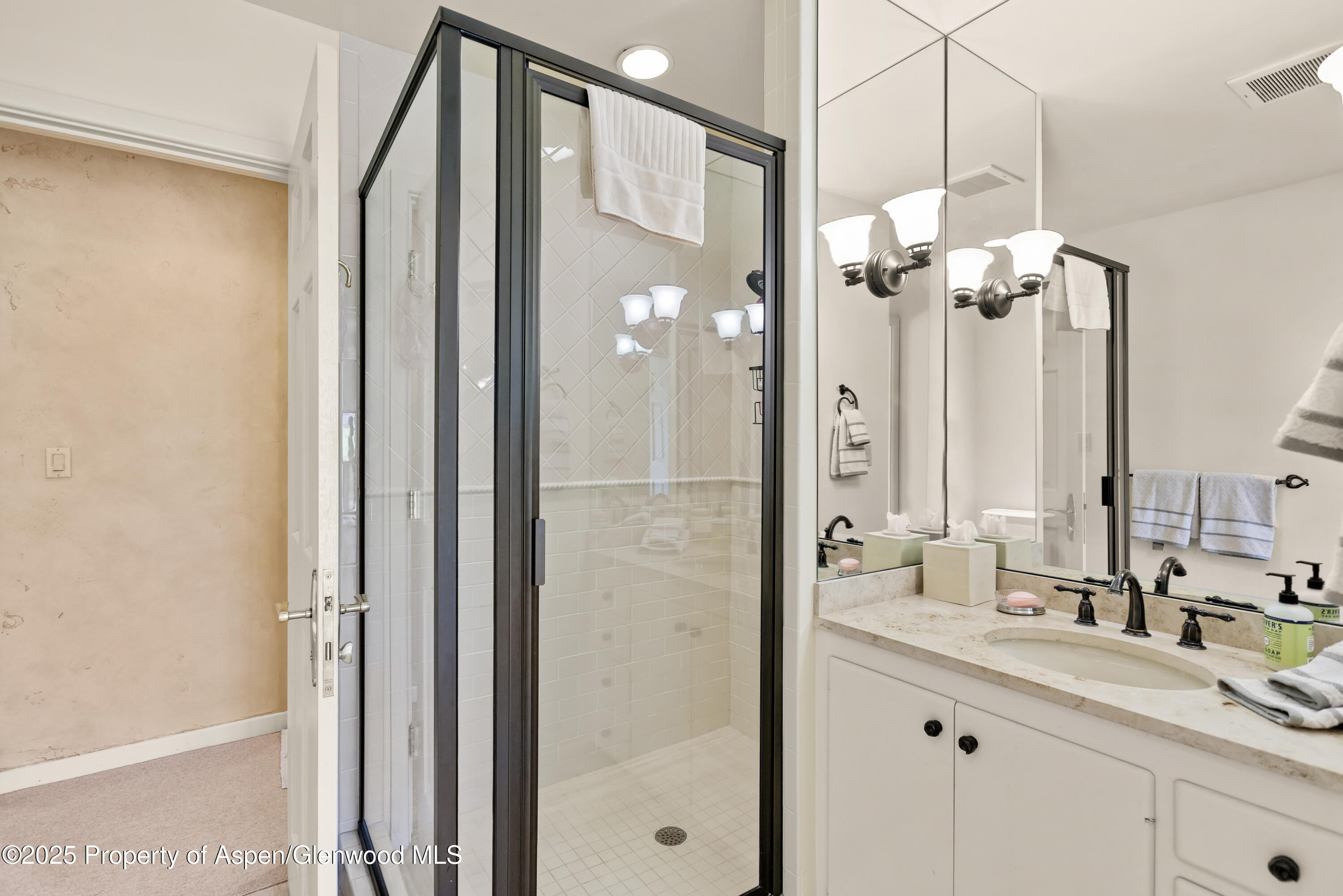 1650 McLain Flats Road Aspen, CO 81611 - Photo 43 of 72 a bathroom with a granite countertop sink mirror and a shower