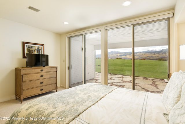 a view of a two chairs in the patio