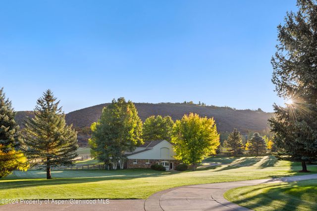 a view of a park with large trees