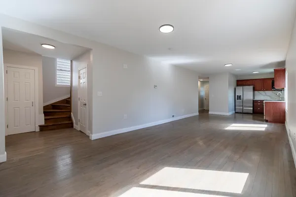 a open kitchen with cabinets and wooden floor