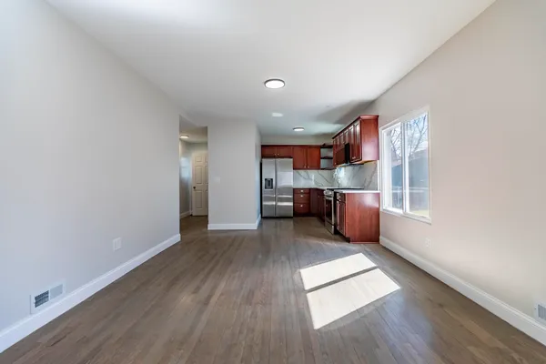 a kitchen with stainless steel appliances granite countertop a stove microwave and refrigerator