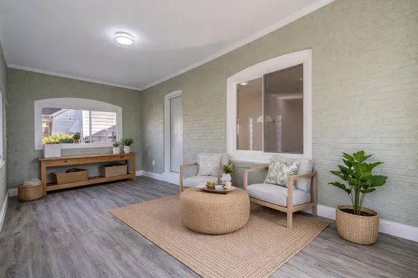a living room with furniture and a potted plant
