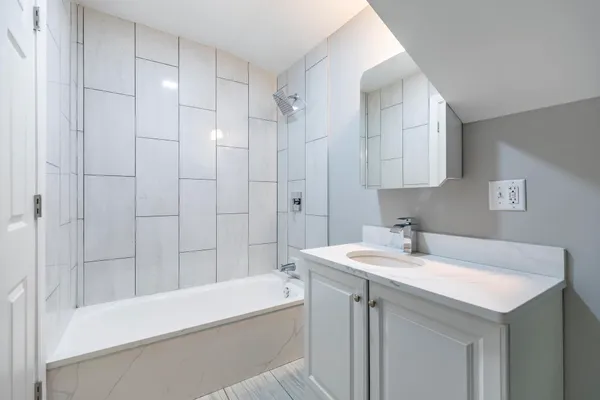 a bathroom with a bathtub and a sink
