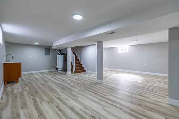 a view of a kitchen with wooden floor and a sink