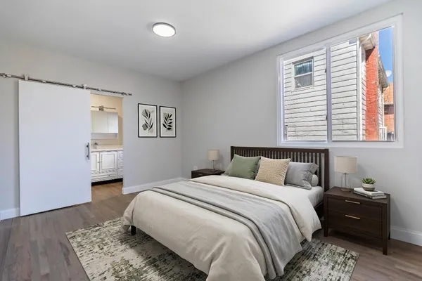a bedroom with a bed and a couch