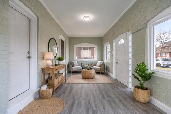 a living room with furniture and potted plants