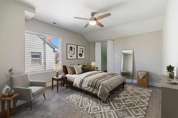 a bedroom with a bed a couch and a window