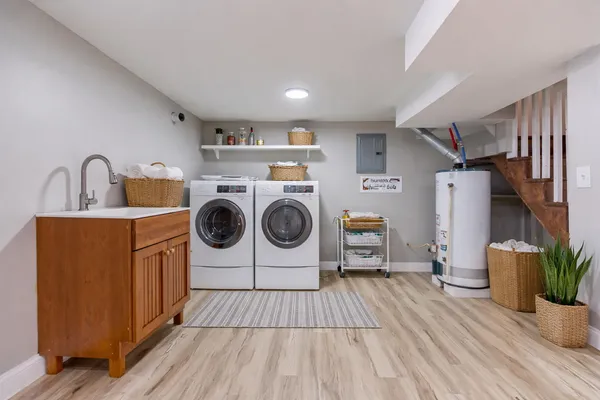 a utility room with sink dryer and washer