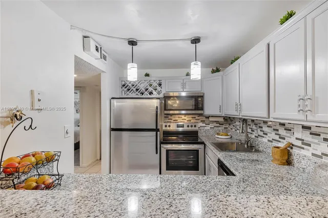 a kitchen with a refrigerator and a sink