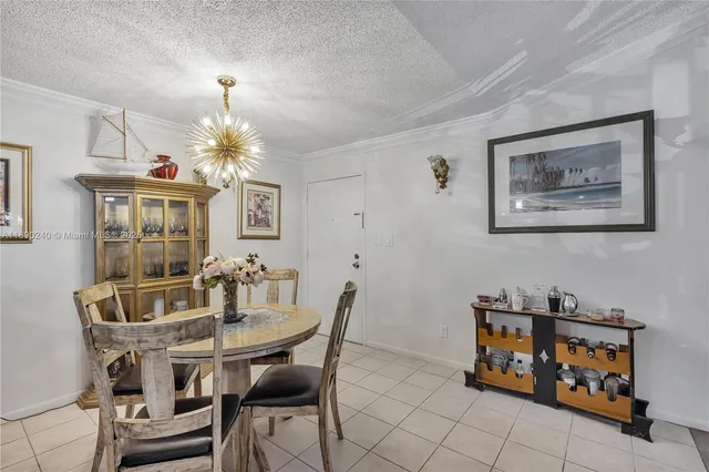 a dining room with furniture and chandelier