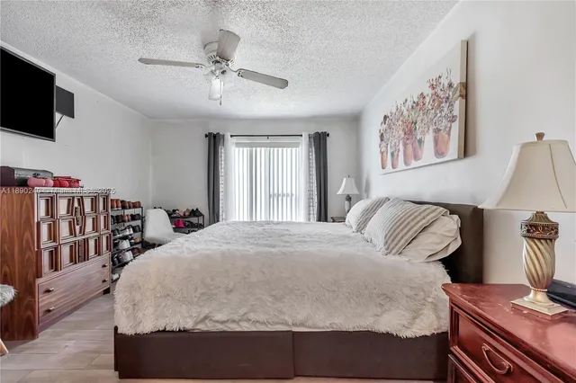 a bedroom with a large bed and a flat screen tv