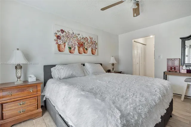 a bedroom with a bed and a painting on the wall