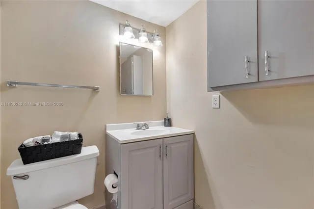 a bathroom with a sink toilet vanity and tub