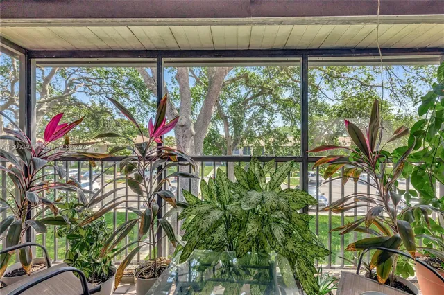 a view of swimming pool with a yard from a balcony