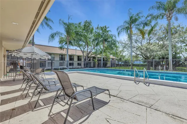 a swimming pool with outdoor seating and yard