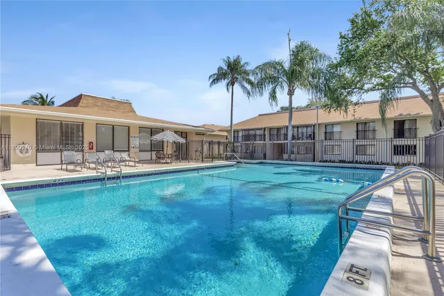 a view of a house with a yard patio and swimming pool