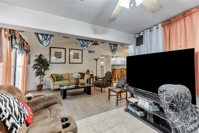 a living room with furniture gym equipment and a flat screen tv