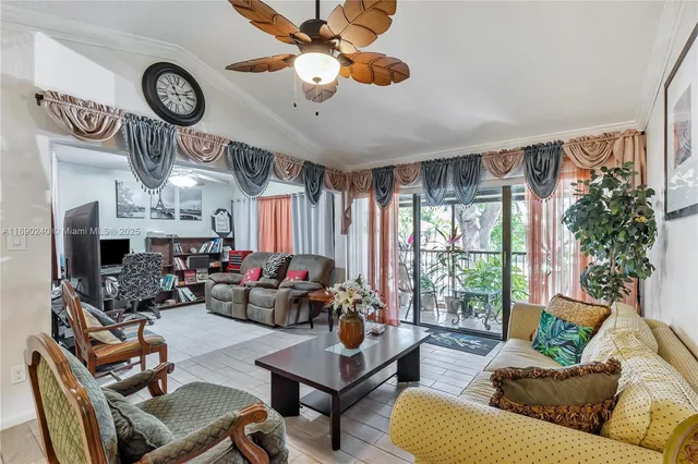 a living room with furniture a clock and a large window