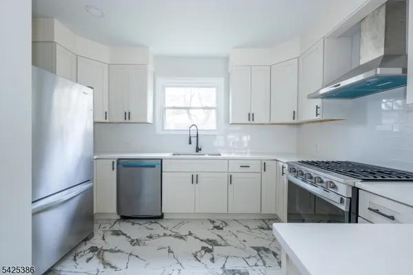 a kitchen with a refrigerator sink and cabinets