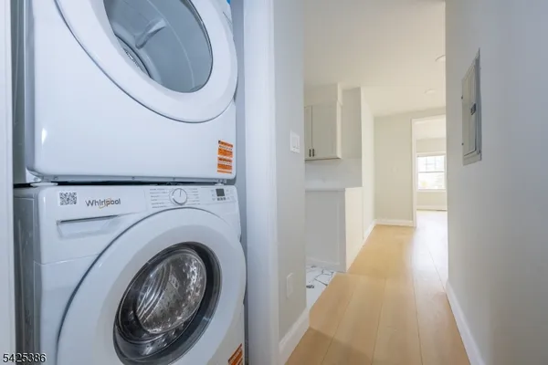 a view of a hallway with washer and dryer