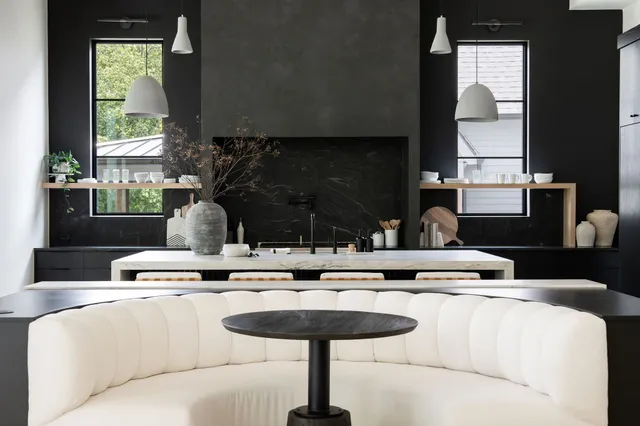a kitchen with a counter top space appliances and windows