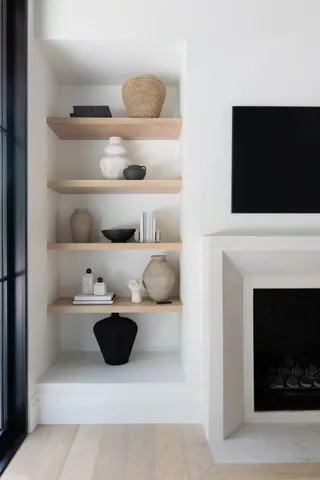 a kitchen view with a fireplace and lots of wooden cabinets