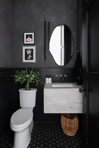 a bathroom with a sink toilet and mirror