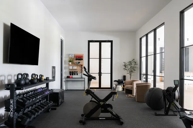 a view of a livingroom with workspace and a window