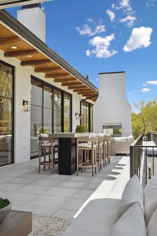a view of a patio with dining table and chairs