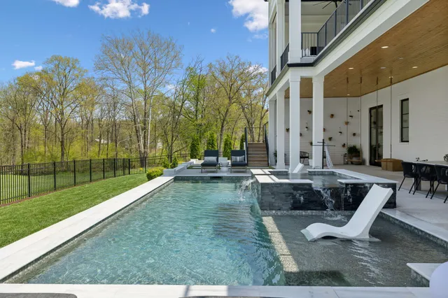 a swimming pool with outdoor seating and yard